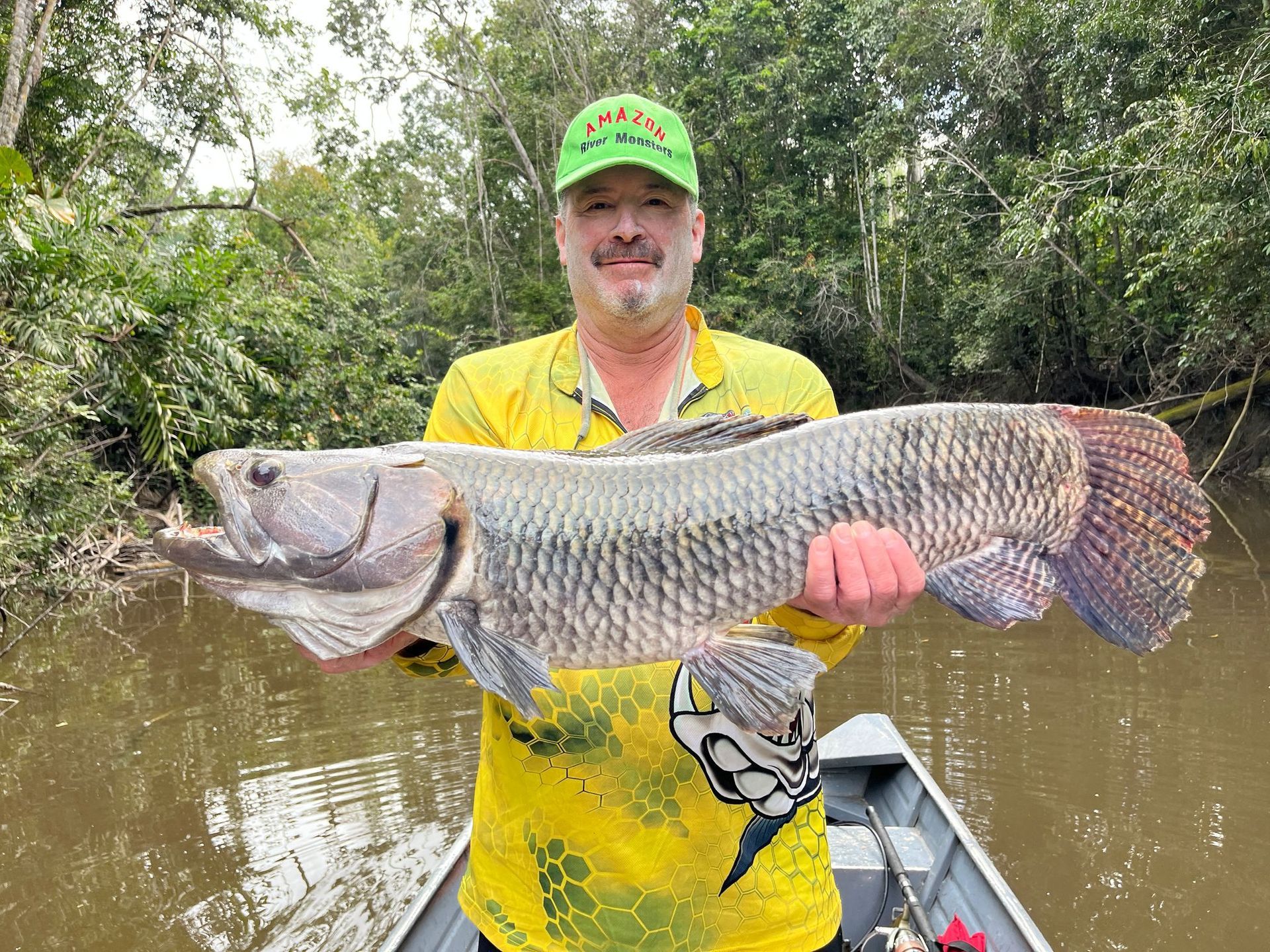 Angler with giant Amazon River fish at remote fishing destination