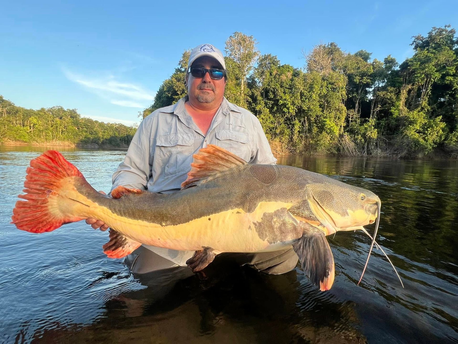 Jungle specialist holding large Amazon River trophy fish