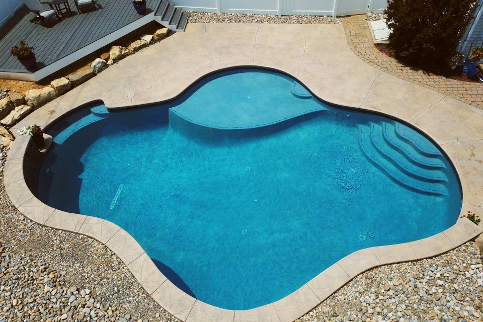 an aerial view of a large blue swimming pool