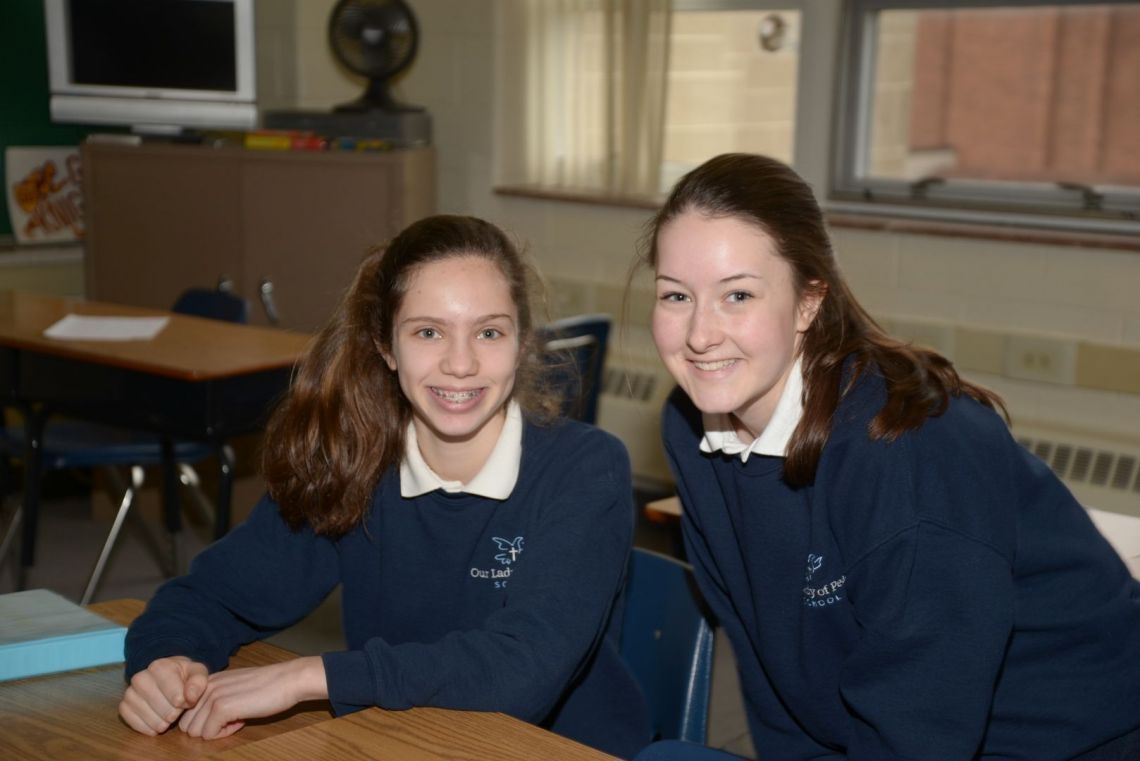 Two girls wearing uniforms with the letter y on them