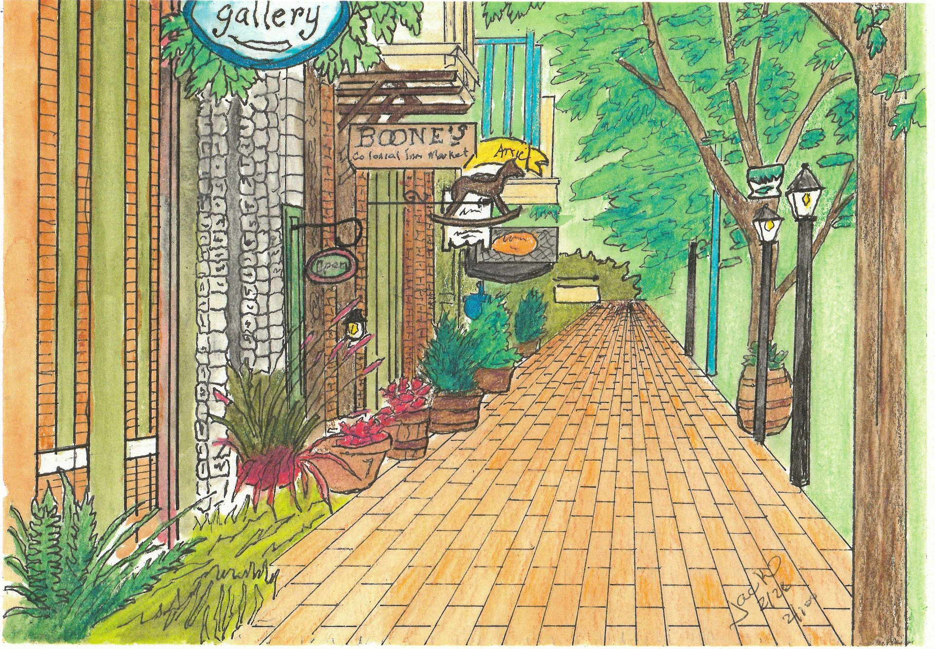 A tree-lined brick walkway past a gallery entrance with hanging signs and street lamps