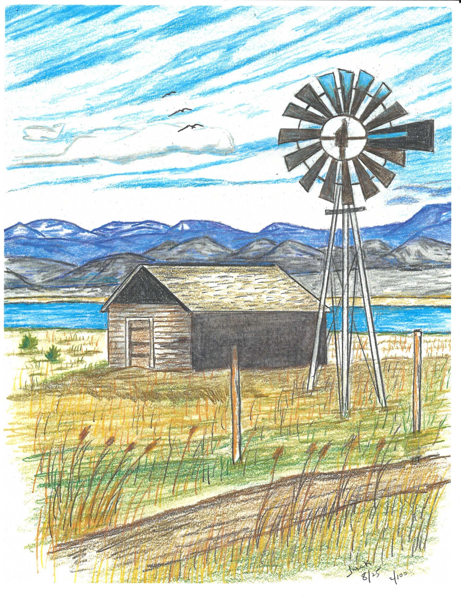 A wooden shack and a metal windmill stand in a dry field before a distant lake and mountain range under a cloudy sky.
