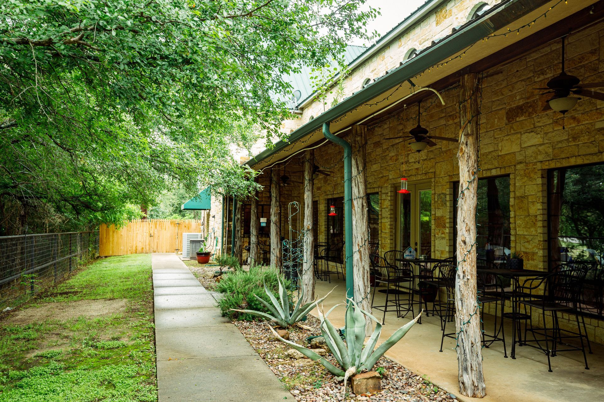 A patio area with tables and chairs in front of a building