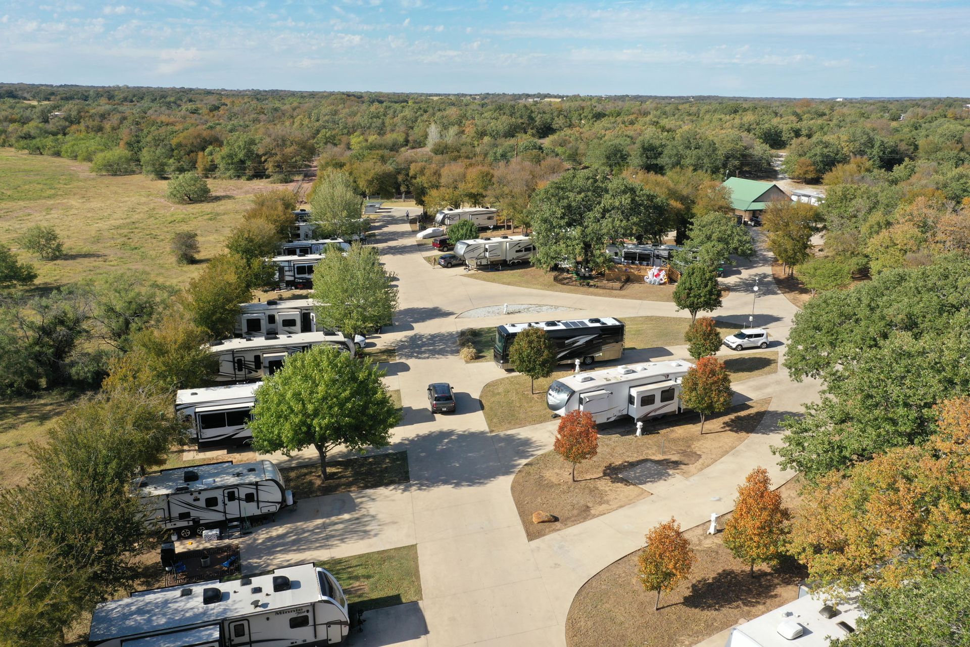 An aerial view of a rv park with a lot of rvs parked in a lot.