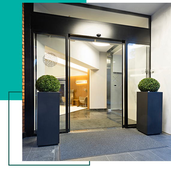 A sliding glass door with two potted plants in front of it A sliding glass door with two potted plants in front of it