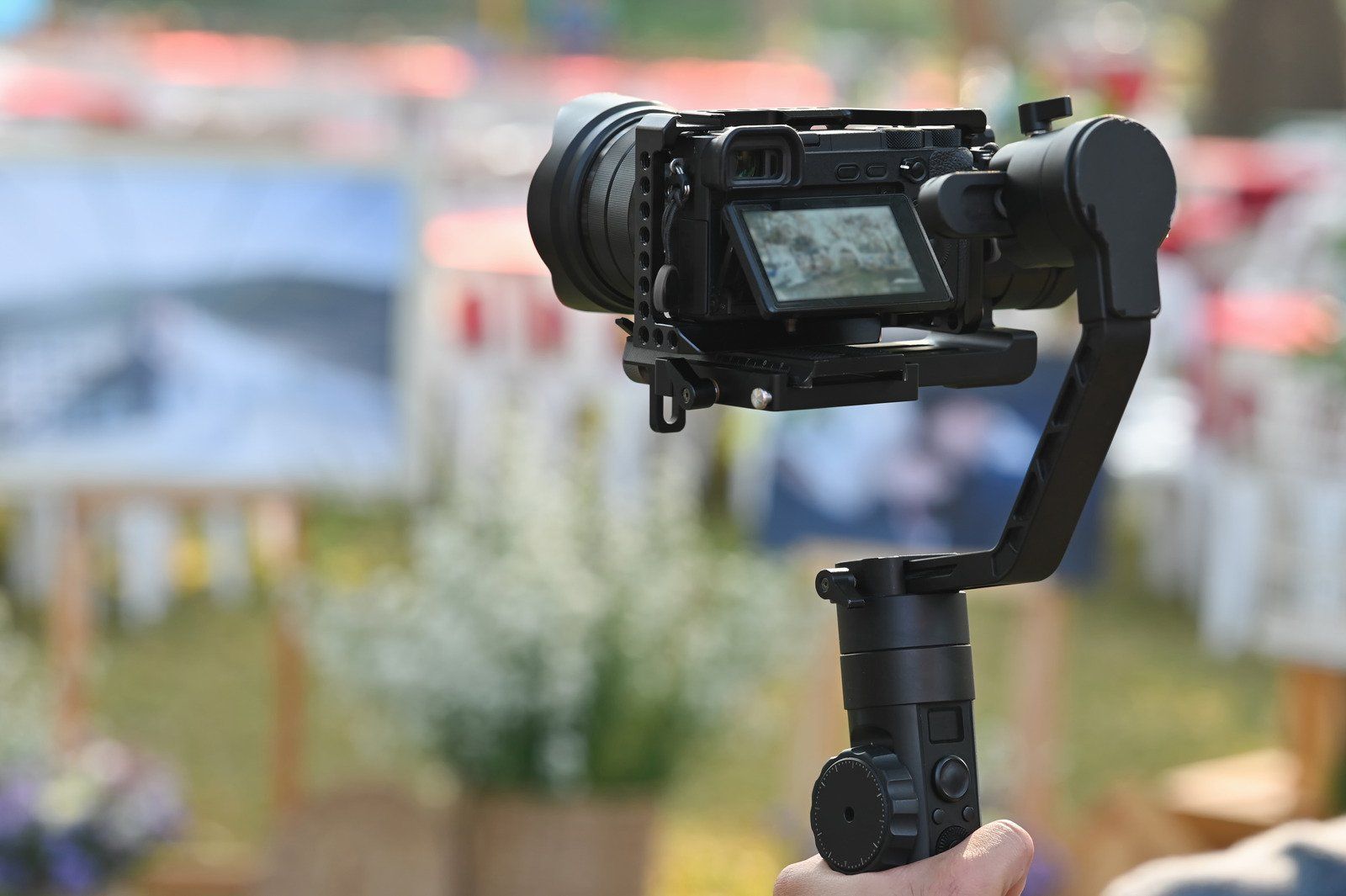 A person is holding a camera on a gimbal.