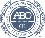 The logo for the american board of orthodontics is blue and white.