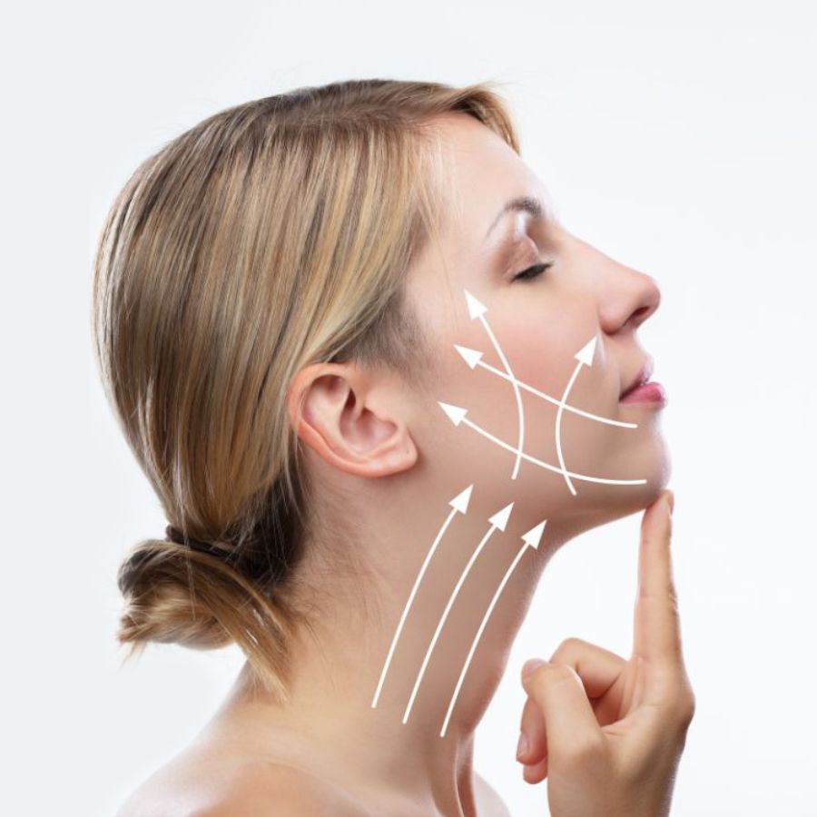 A woman pointing to her chin with arrows mapped out on her face.