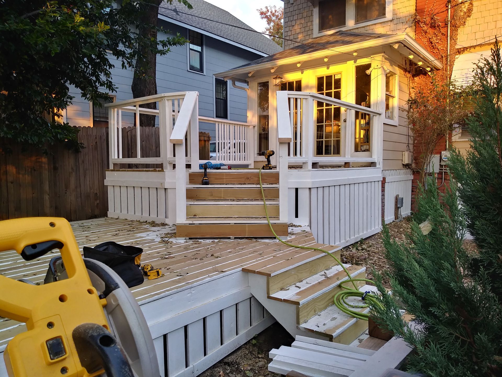 A circular saw is sitting in front of a deck under construction