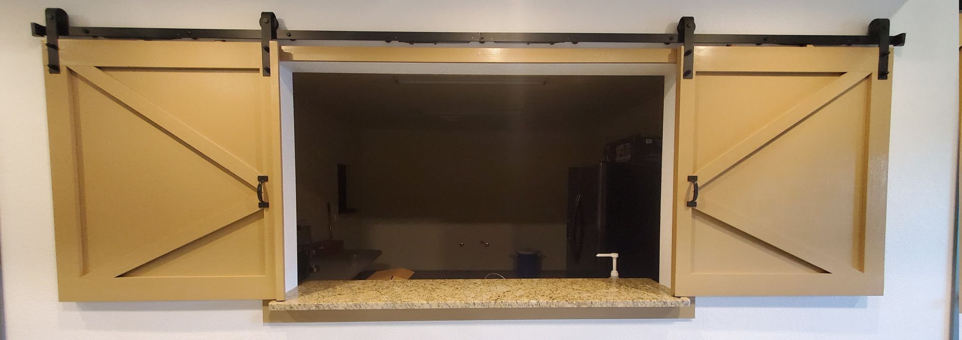 A window with sliding barn doors on the side of it.