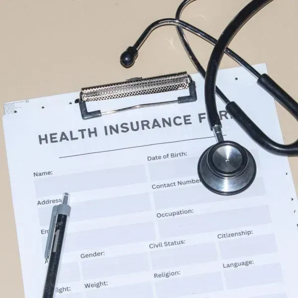 Health insurance form with a stethoscope on top on a desk