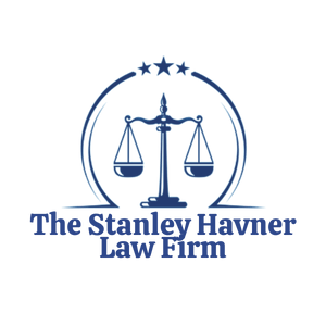 Blue law firm logo with scales of justice and stars, reading “The Stanley Havner Law Firm”