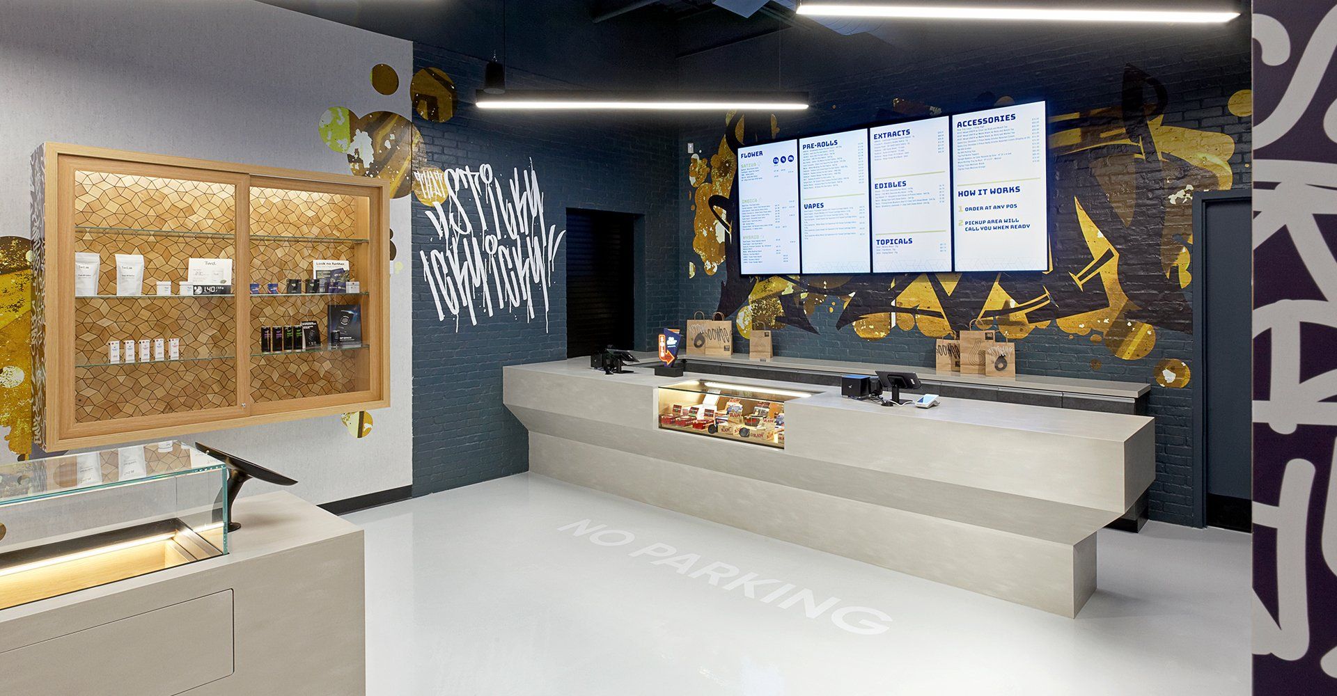A room with a counter and a large screen on the wall.