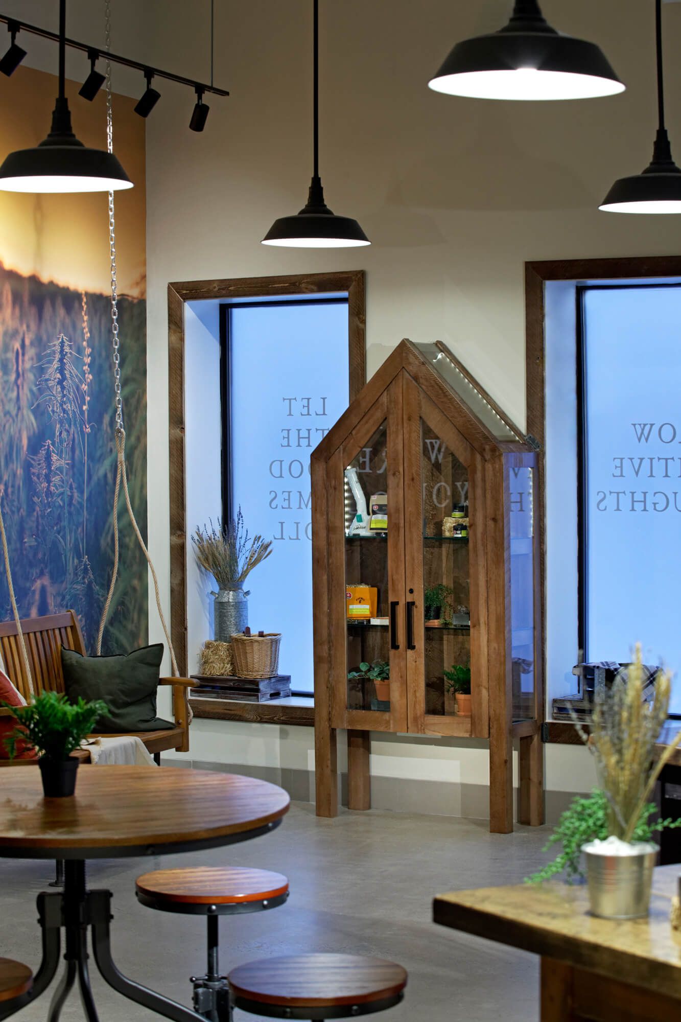 A room with a table and chairs and a display case
