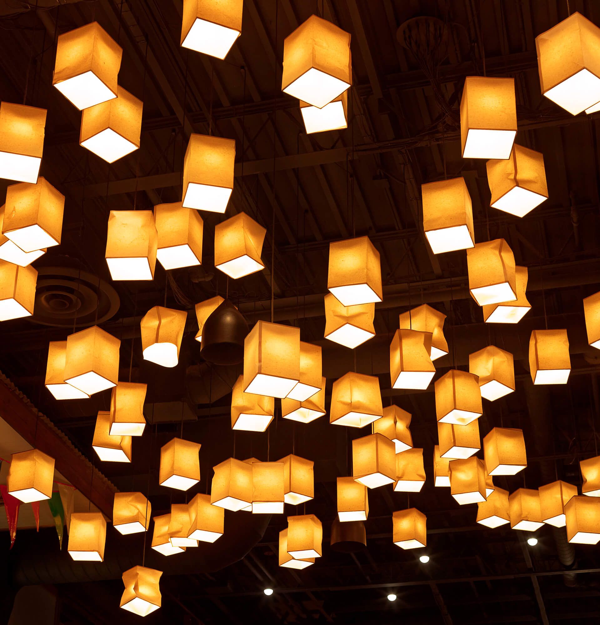 A bunch of square lights hanging from the ceiling