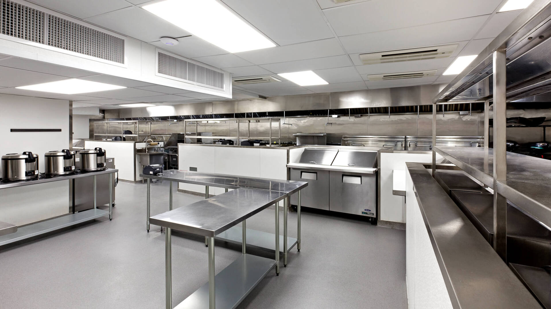 A large kitchen with lots of stainless steel appliances