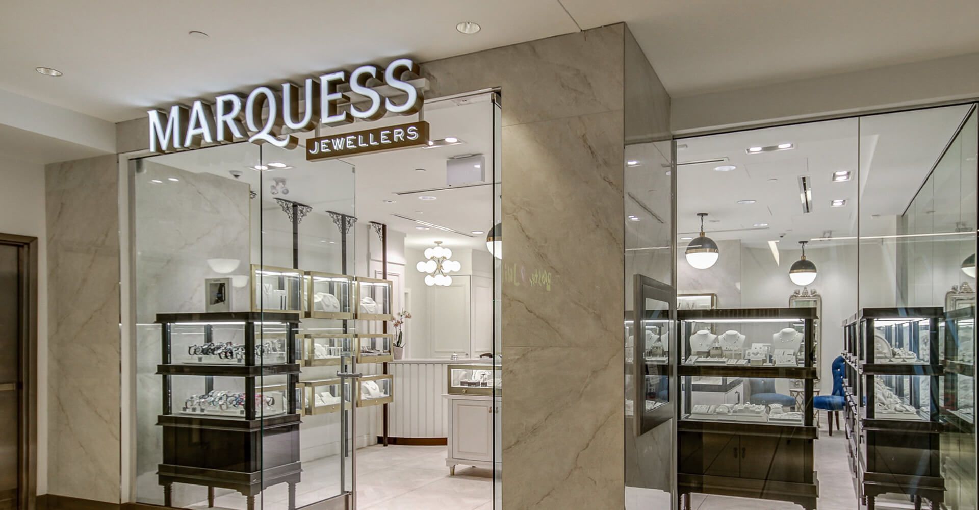 A store front with a glass door and a sign that says marquess jewelers.