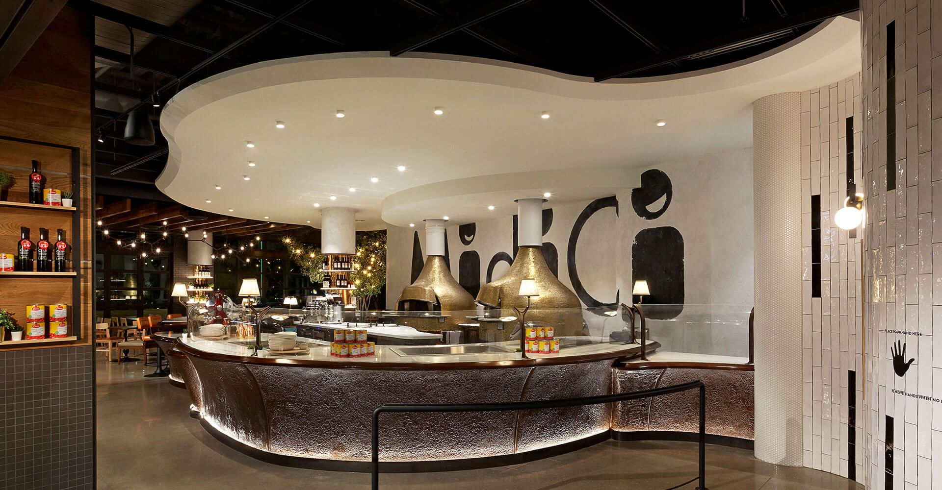 A restaurant with a long counter and a sign on the wall.
