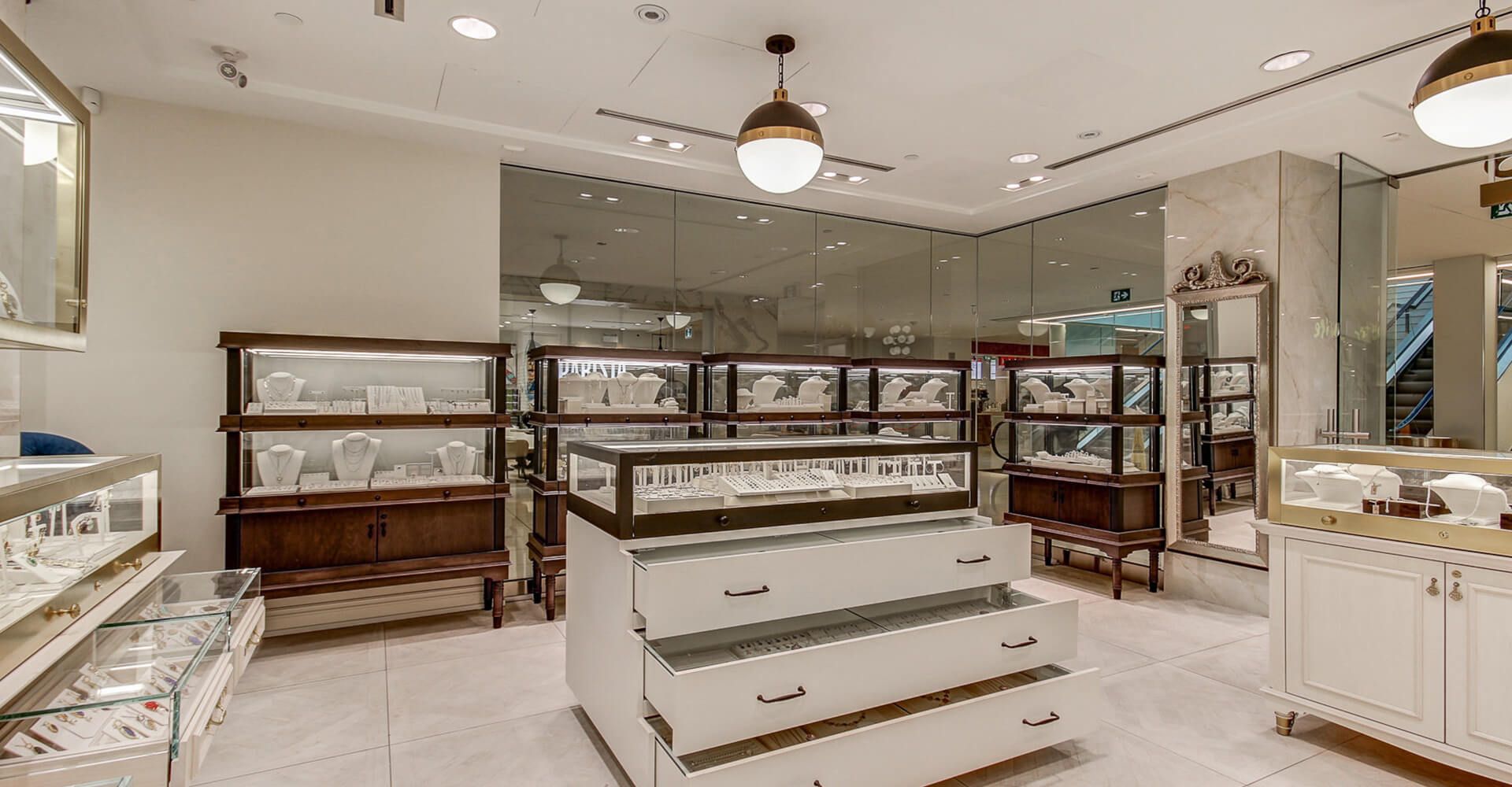 A jewelry store with lots of drawers and shelves filled with jewelry.