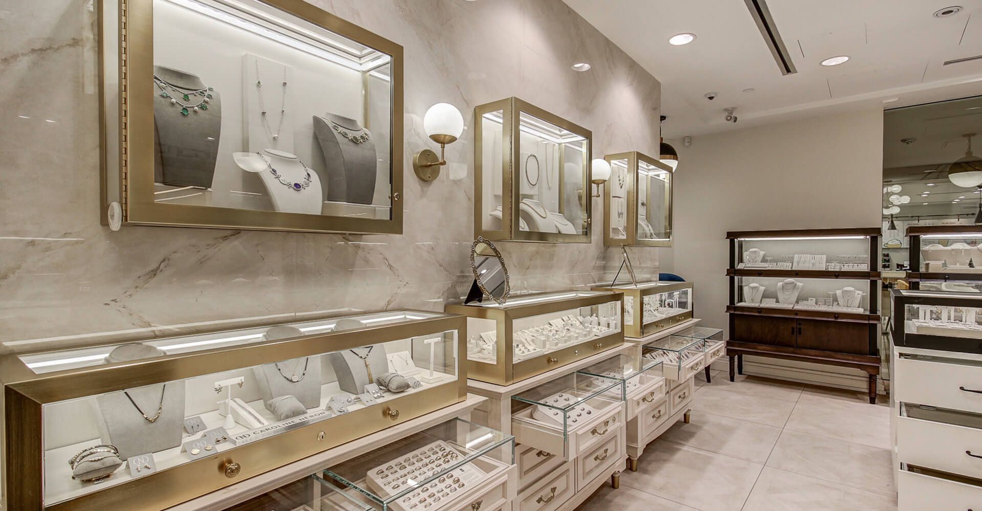 A jewelry store with lots of display cases filled with jewelry.