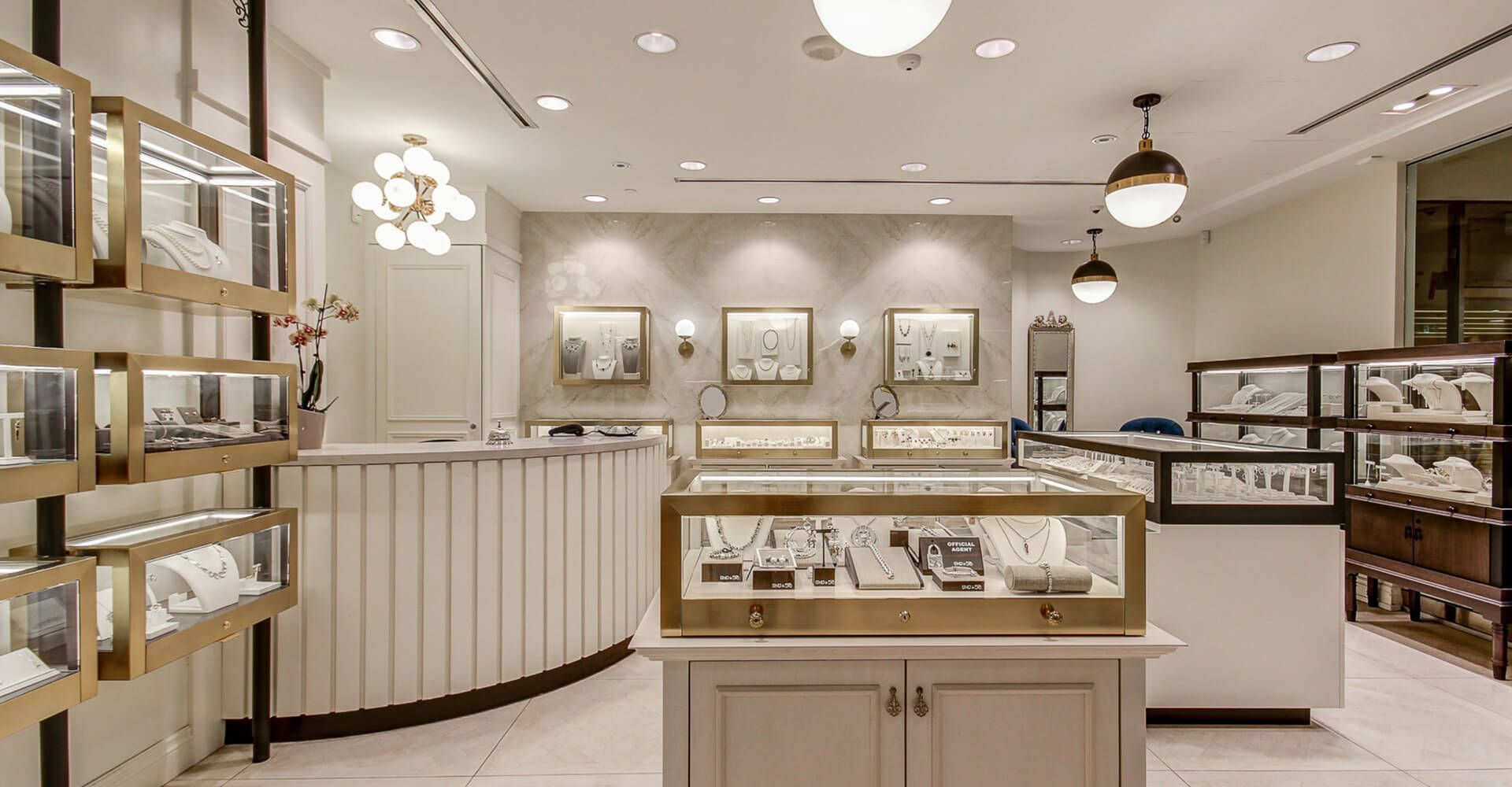 A jewelry store with lots of display cases and a counter.