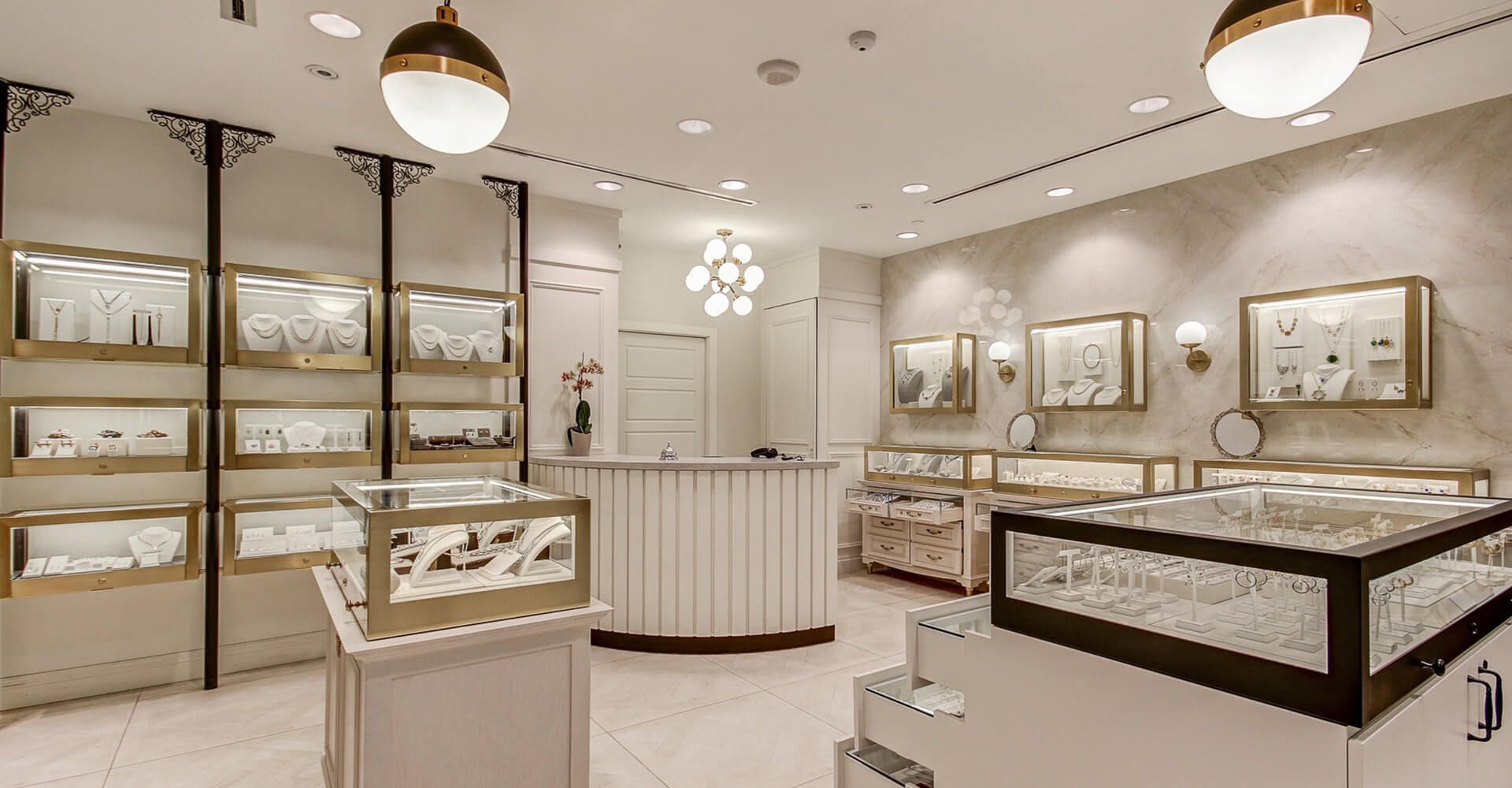 A jewelry store with a counter and display cases filled with jewelry.