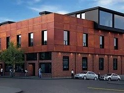 An artist 's impression of a large brick building with cars parked in front of it.