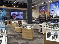 The inside of a camera store with a large screen on the wall.