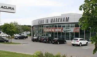 Acura in markham is a car dealership with cars parked in front of it.