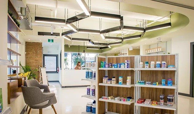 A pharmacy with a lot of shelves and a waiting area.