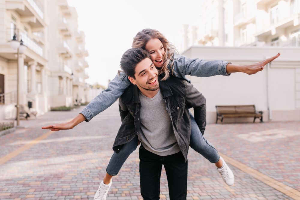 A man is carrying a woman on his back.
