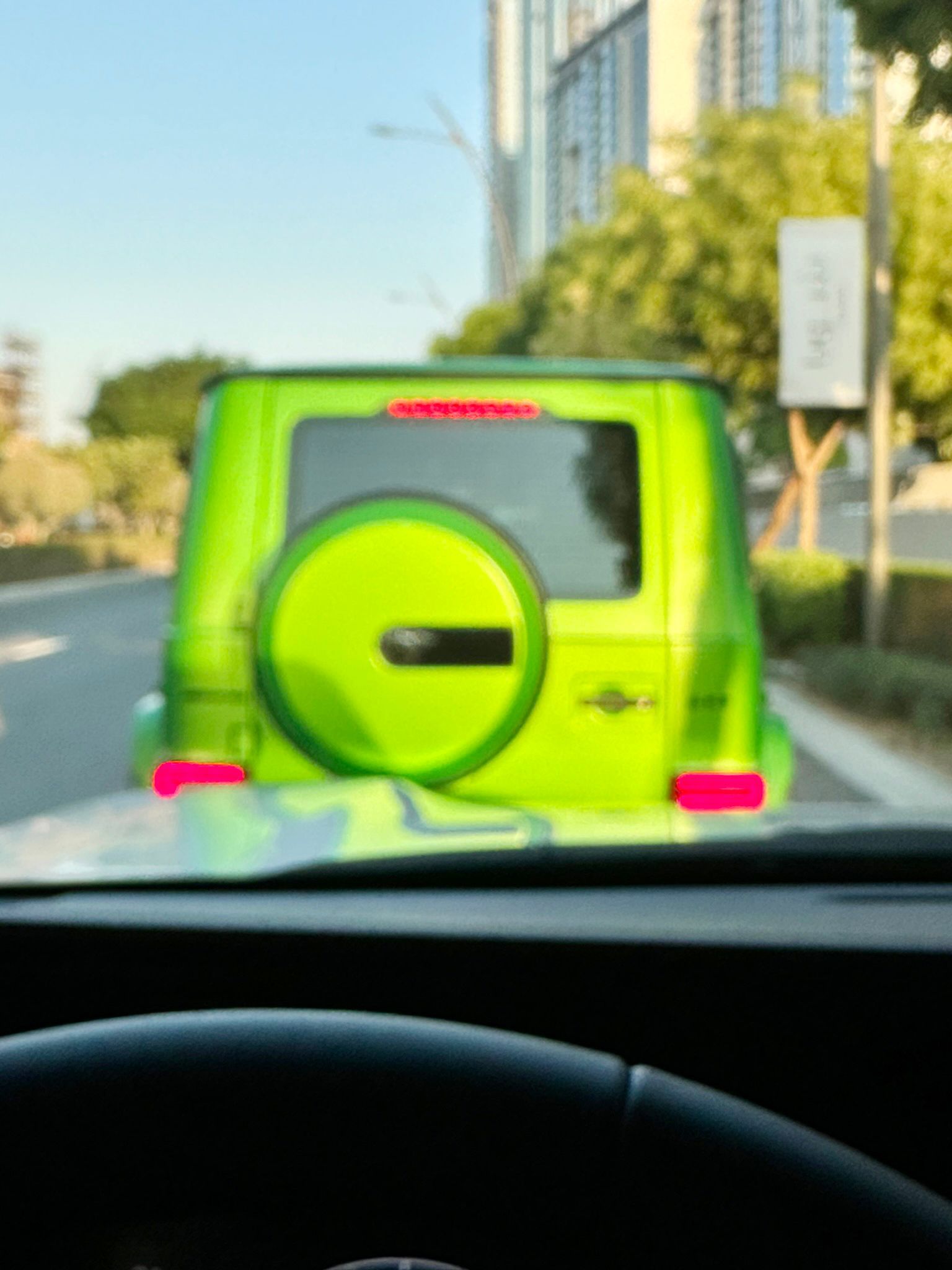 A green van is parked on the side of the road