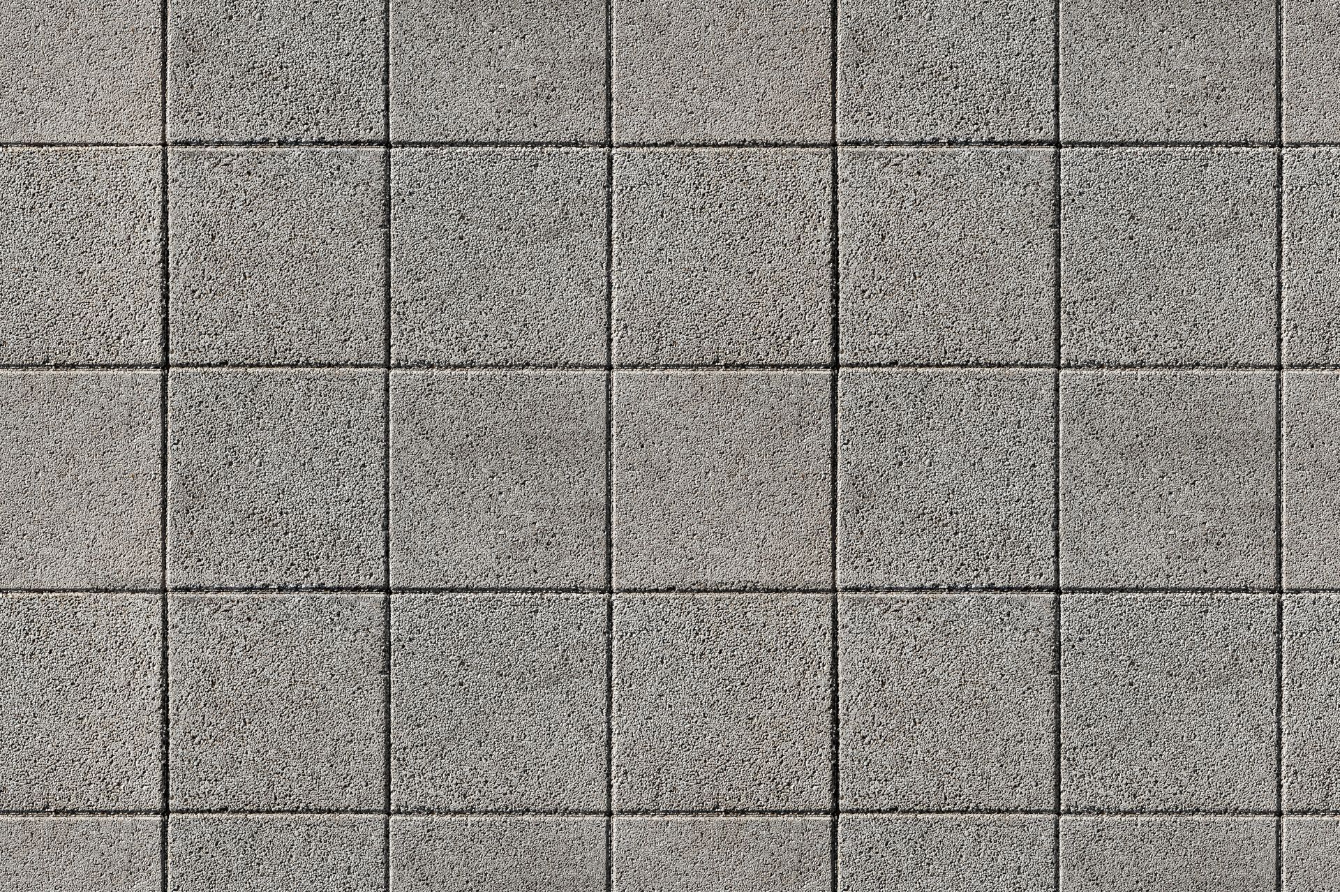 Gray speckled tile wall with a grid of dark grout lines