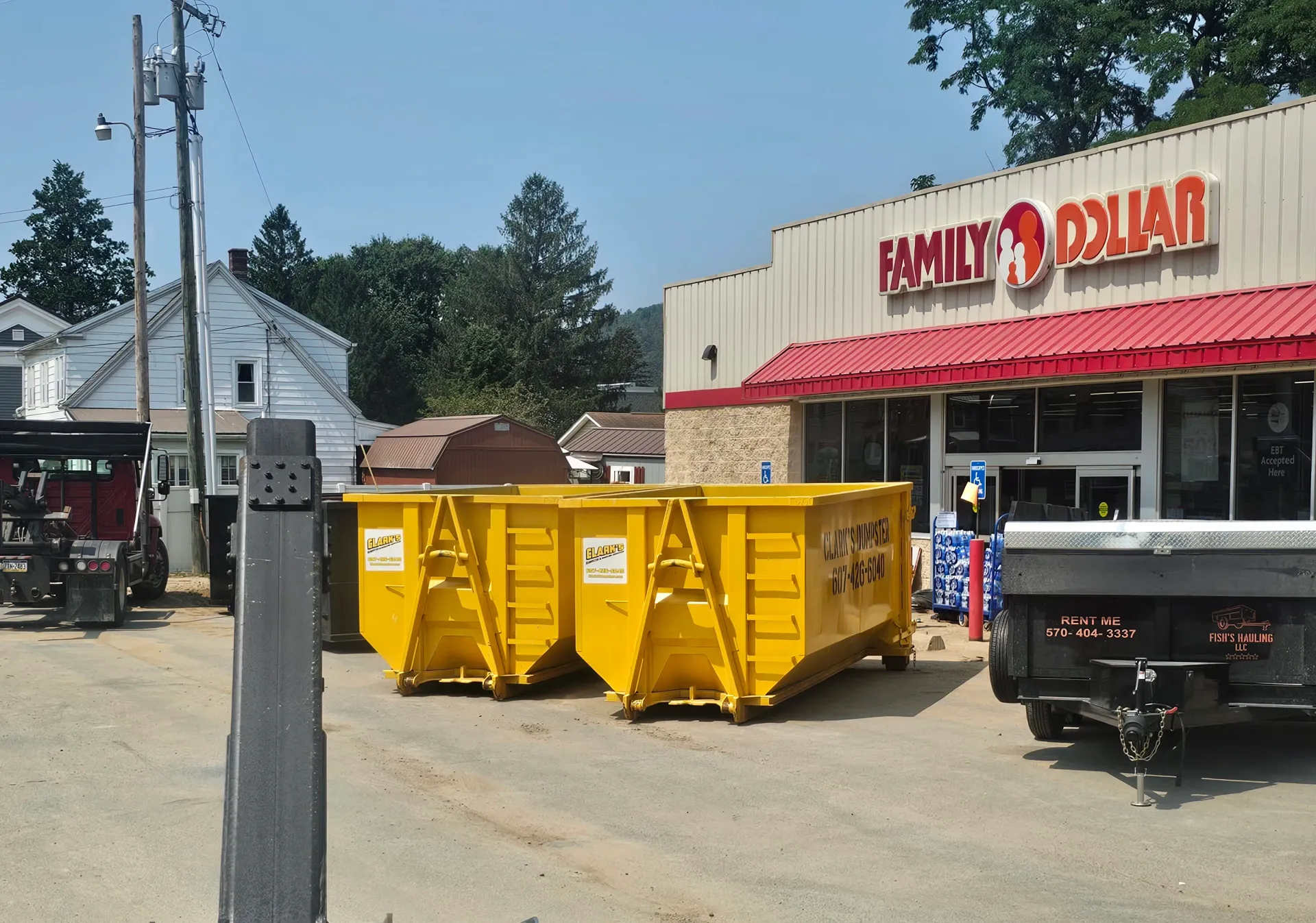 A dumpster in front of a family dollar store