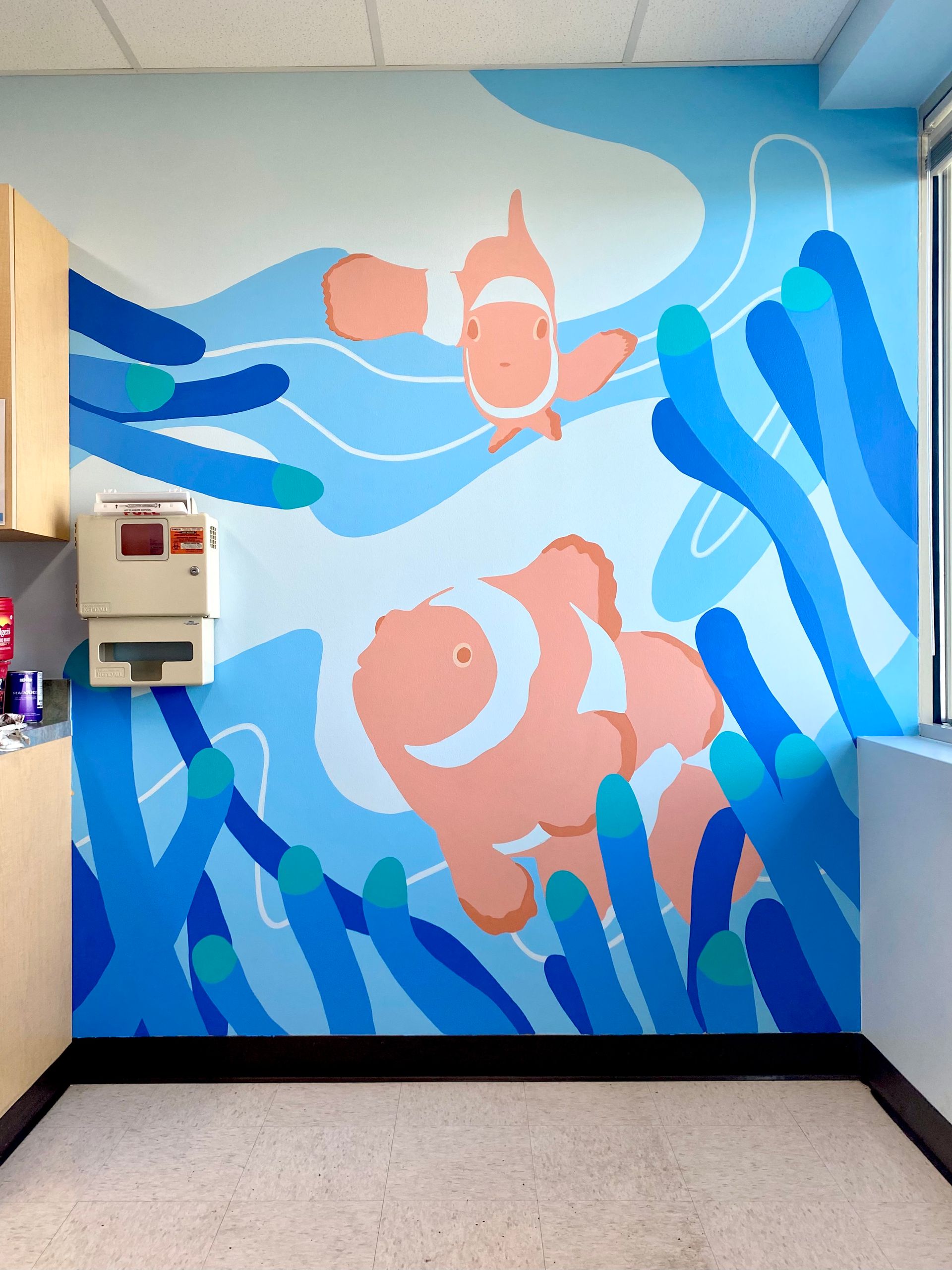 Clownfish and anemone mural in a pediatric exam room at Dell Children's