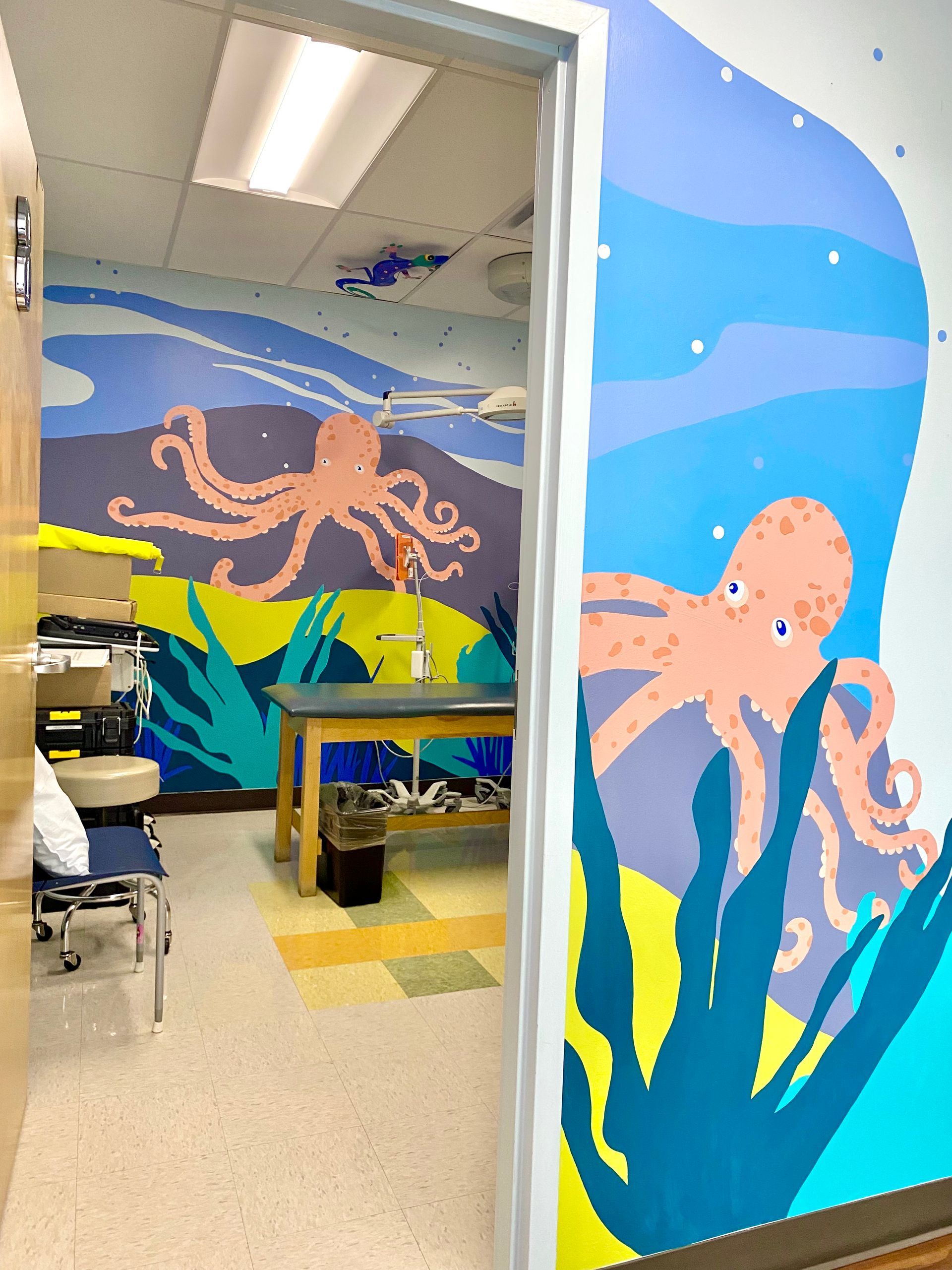 Friendly octopus mural in a pediatric procedure room, Austin