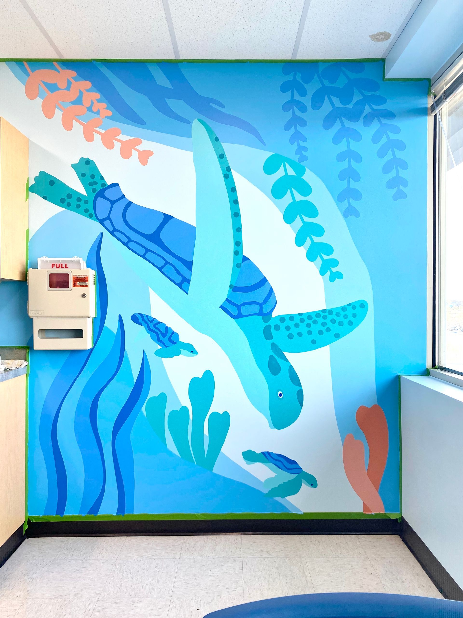 Sea turtle mural with baby turtles in a children's exam room in Austin