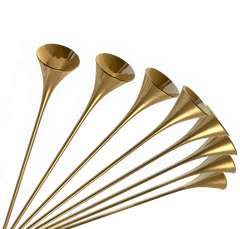 Eight gold trumpet horns fanned out on a white background