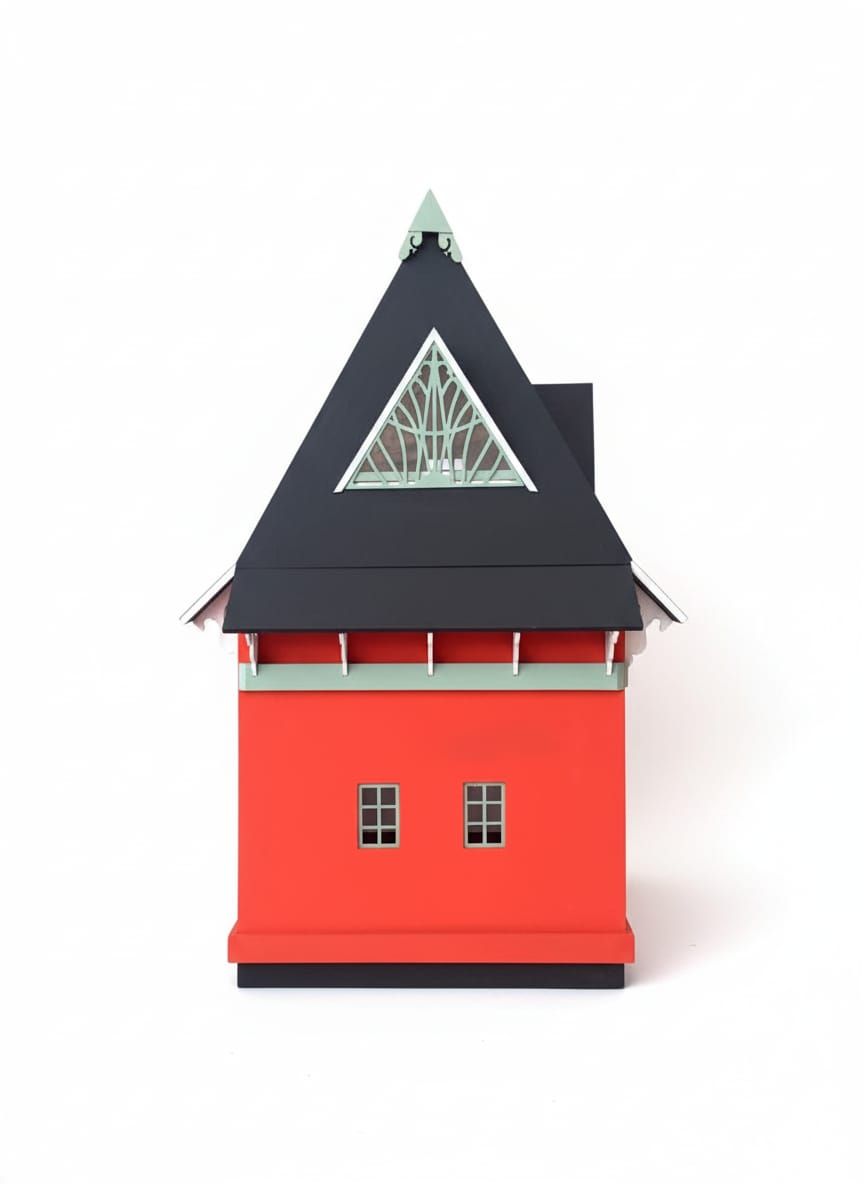 Casa modelo roja y negra con techo triangular y ventanas pequeñas.
