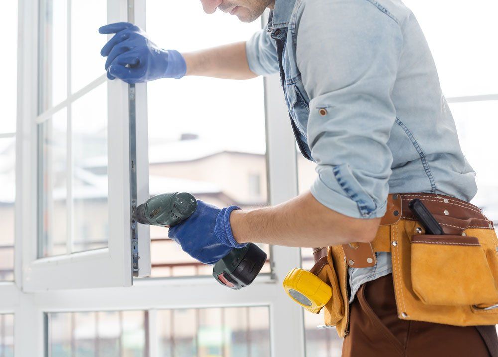 Installing New Window — Newburg, WI — Laubenstein Inc Installing New Window — Newburg, WI — Laubenstein Inc