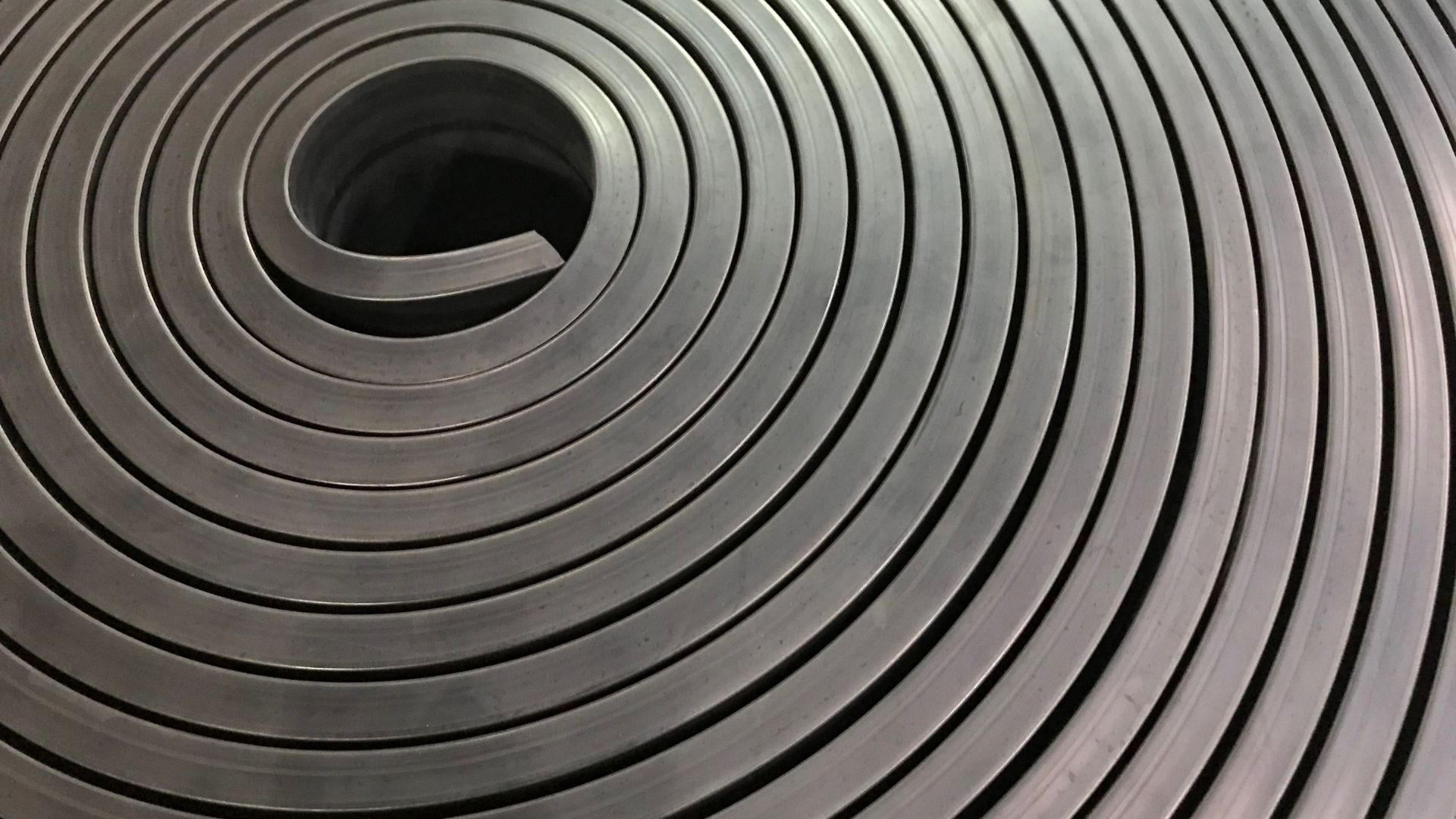 A close up of a metal coil with a hole in the middle
