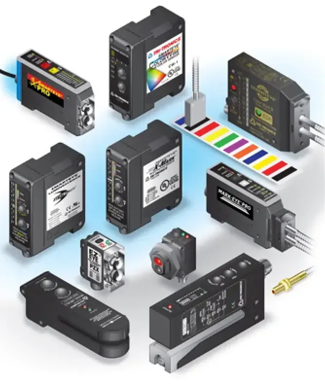 Assorted industrial sensors and control modules on a white background with rainbow color calibration strip
