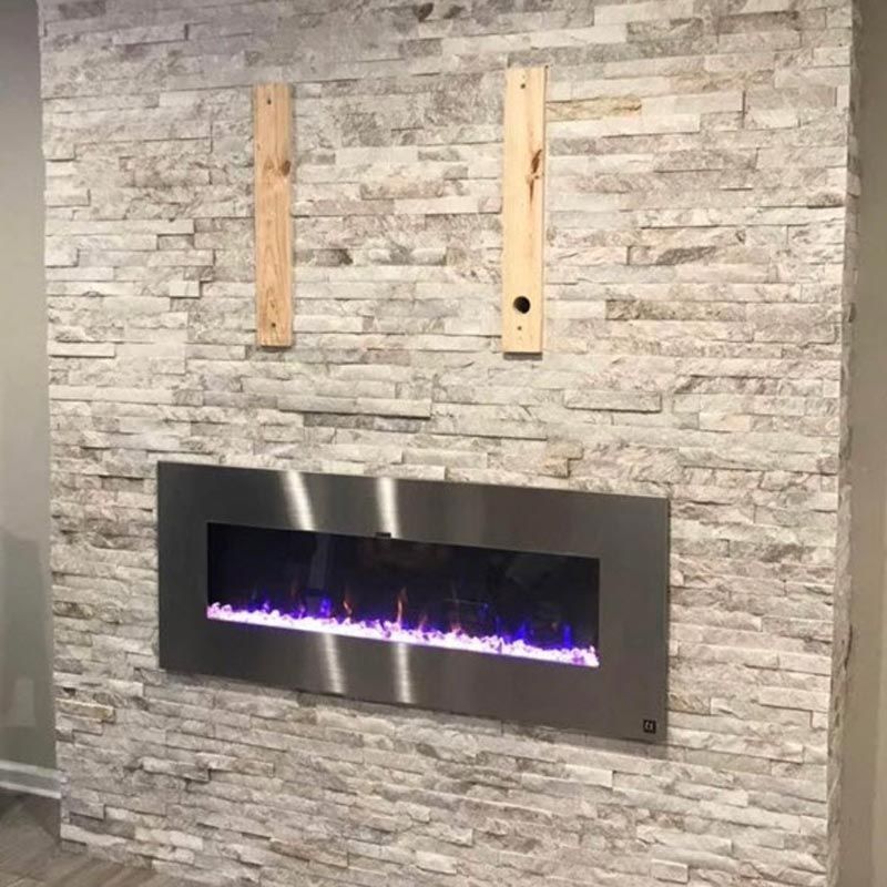 Modern wall-mounted fireplace with purple flames set in a stone accent wall