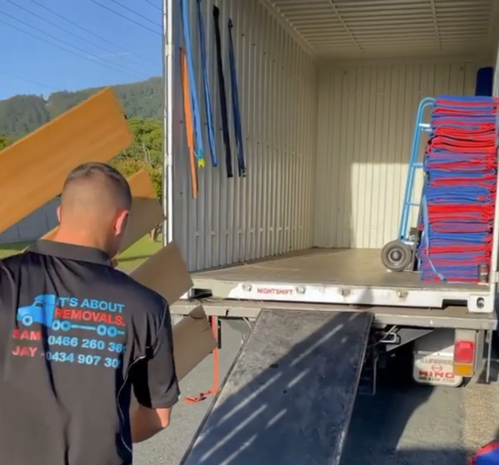 Removalist unloading a removals truck in Wollongong with a ramp down the back.