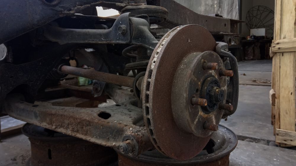 Rusty Car Suspension and Brake System Components in a Garage — Edmonton Tyre and Mechanical Services in Edmonton, QLD