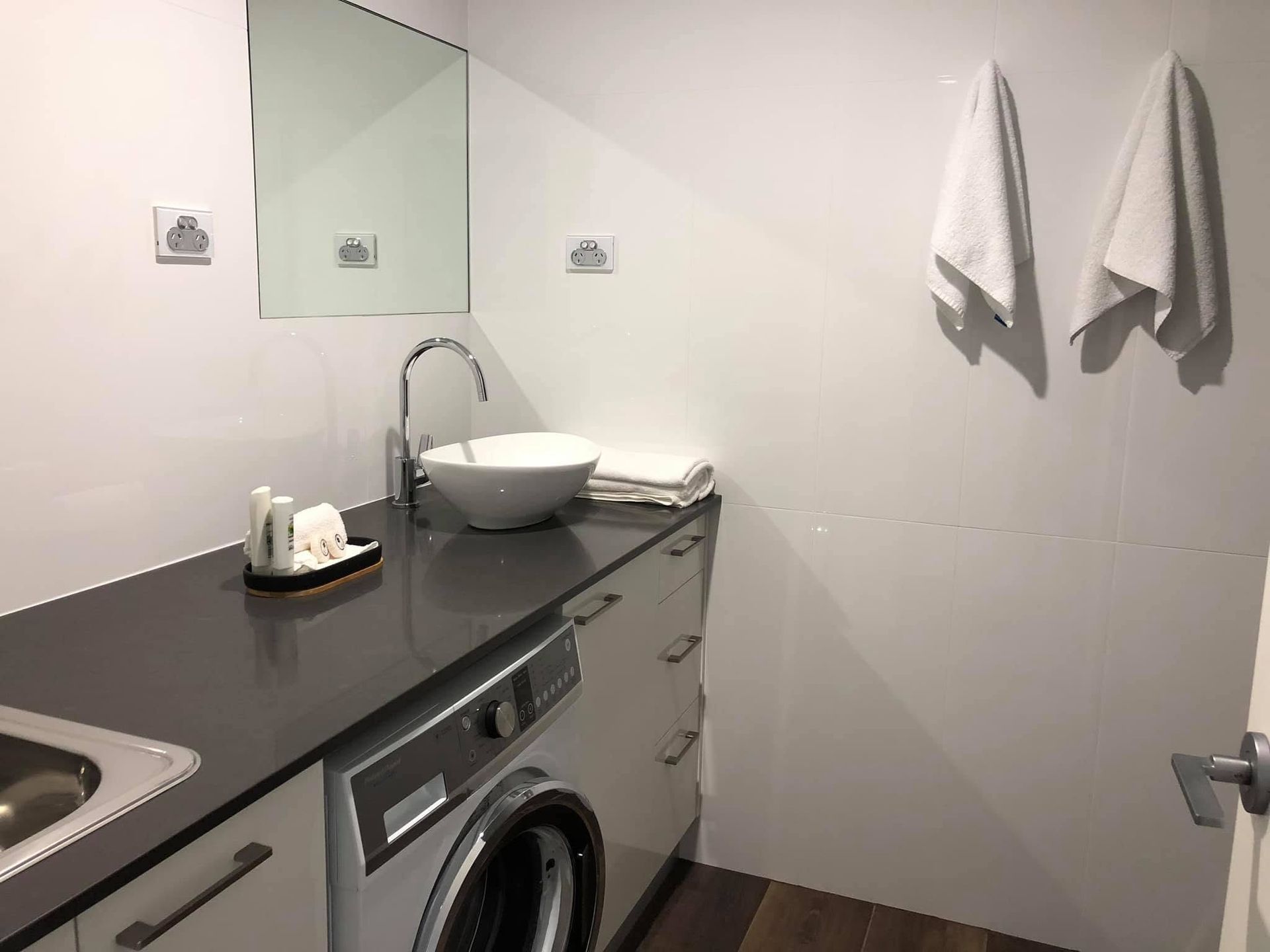 Modern Bathroom With Vanity, Sink, Washing Machine, and Towels on the Wall— Piscopo Kitchens Plus In Forster, NSW