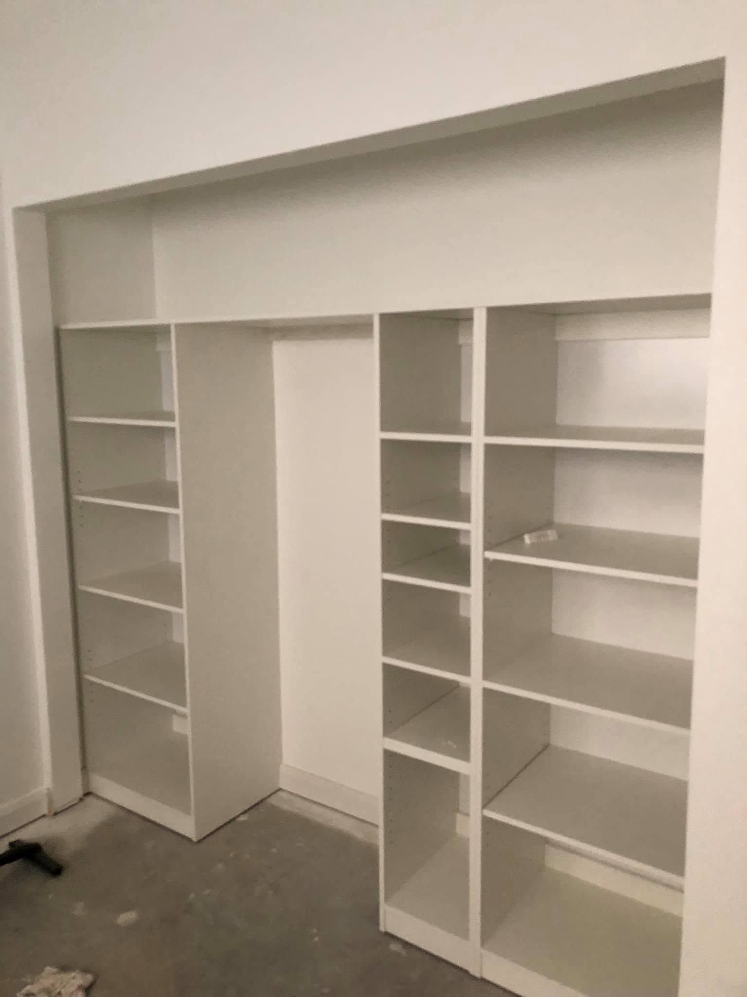 Built-in White Wall Shelving Unit With Open Cubbies and Shelves in an Empty Room— Piscopo Kitchens Plus In Forster, NSW