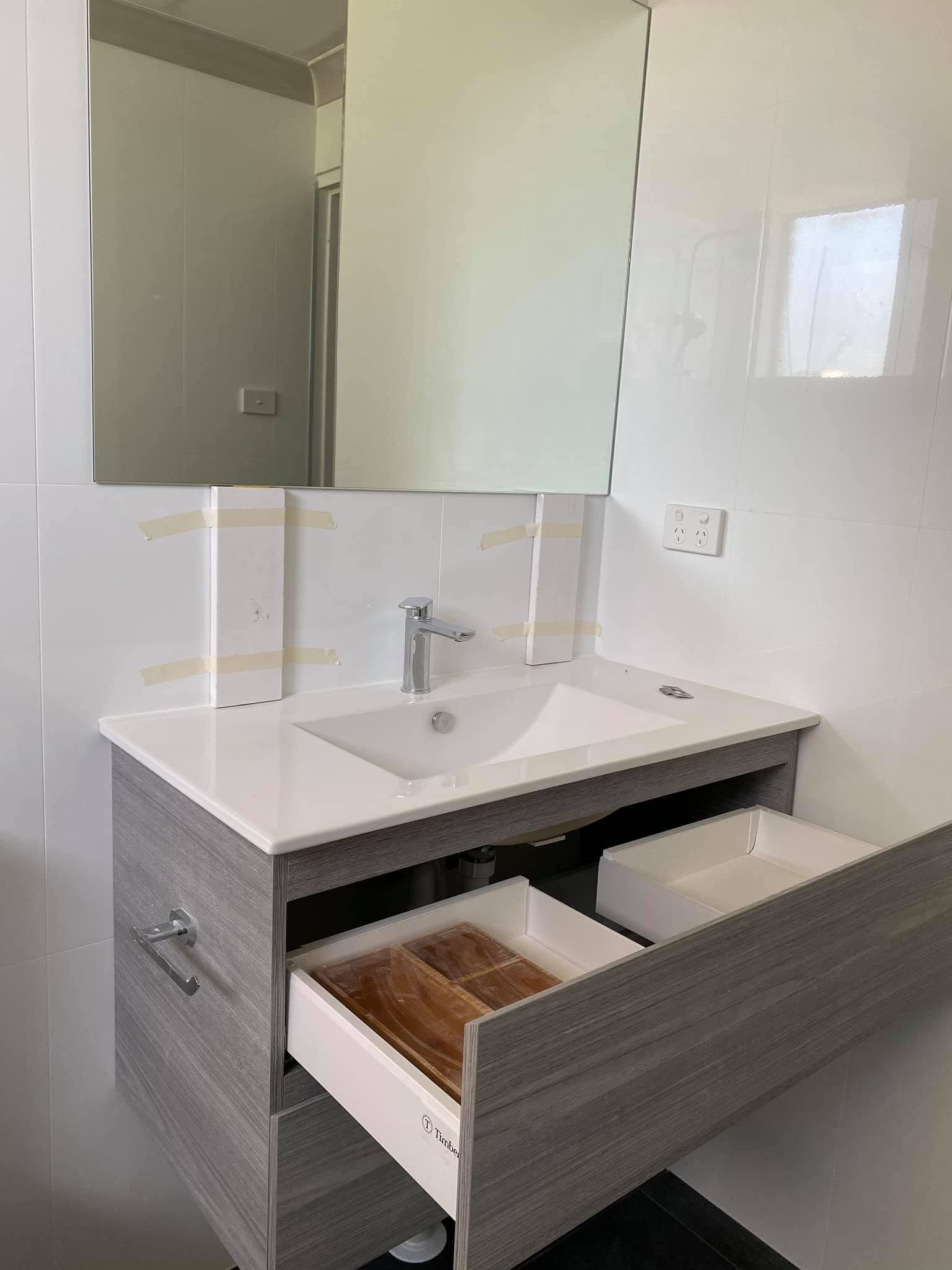 Modern Bathroom Vanity With Sink, Mirror Cabinet, and Open Drawer— Piscopo Kitchens Plus In Forster, NSW