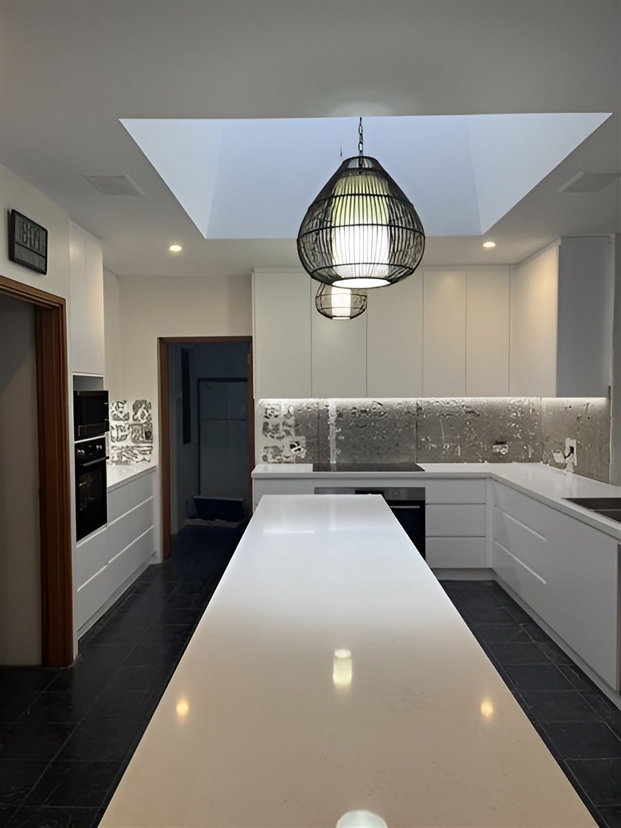 Modern Kitchen With a Long White Island Counter — Piscopo Kitchens Plus In Forster, NSW