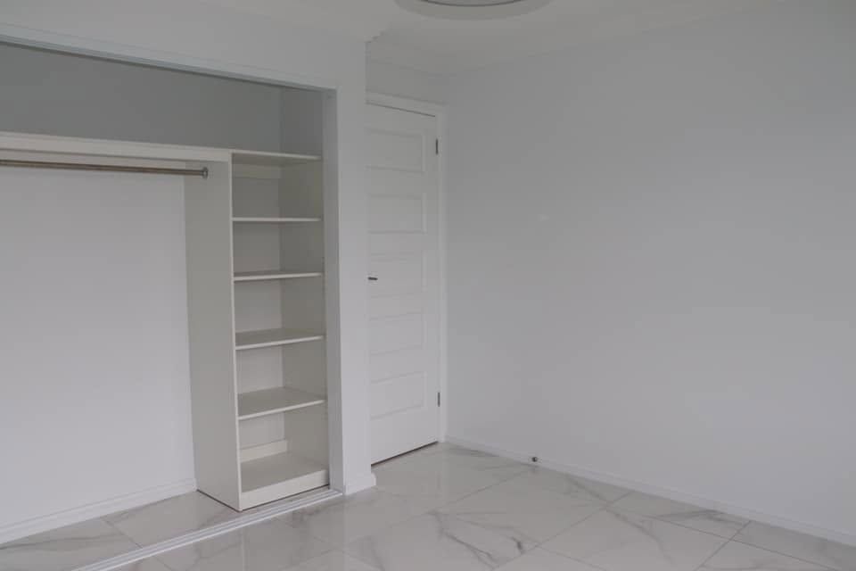 Empty White Room With Built-in Shelving — Piscopo Kitchens Plus In Forster, NSW